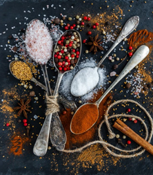 5 teaspoons with various spices, such as salt, pepper and cinnamon