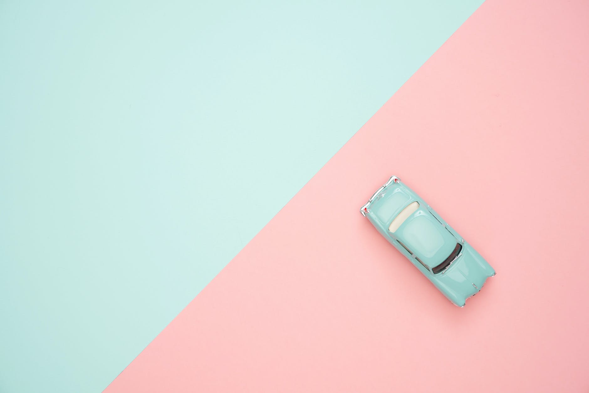 Blue and pink geometric photo with a small blue car 