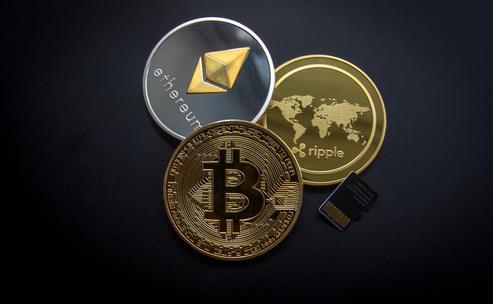 A photo of 3 types of cryptocurrency including Ripple, Ethereum and Bitcoin