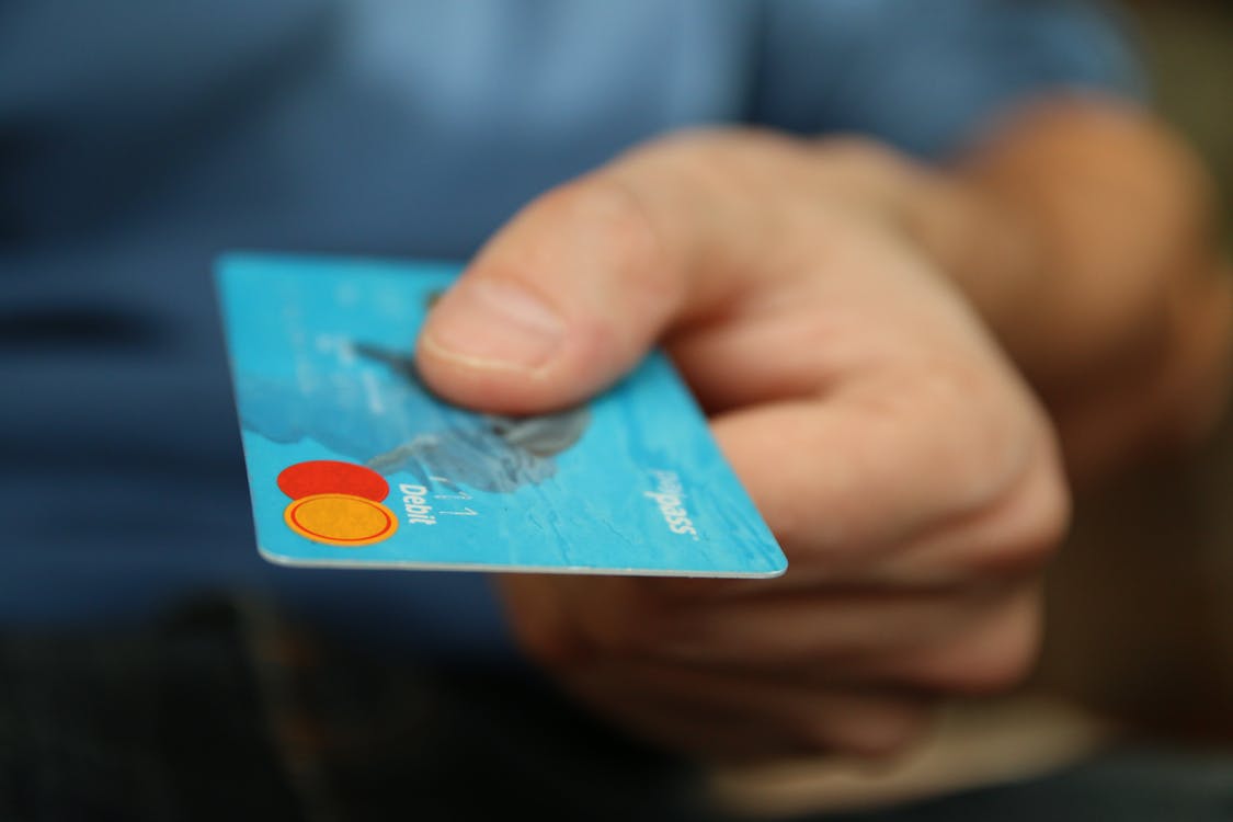 A debit card being offered as payment