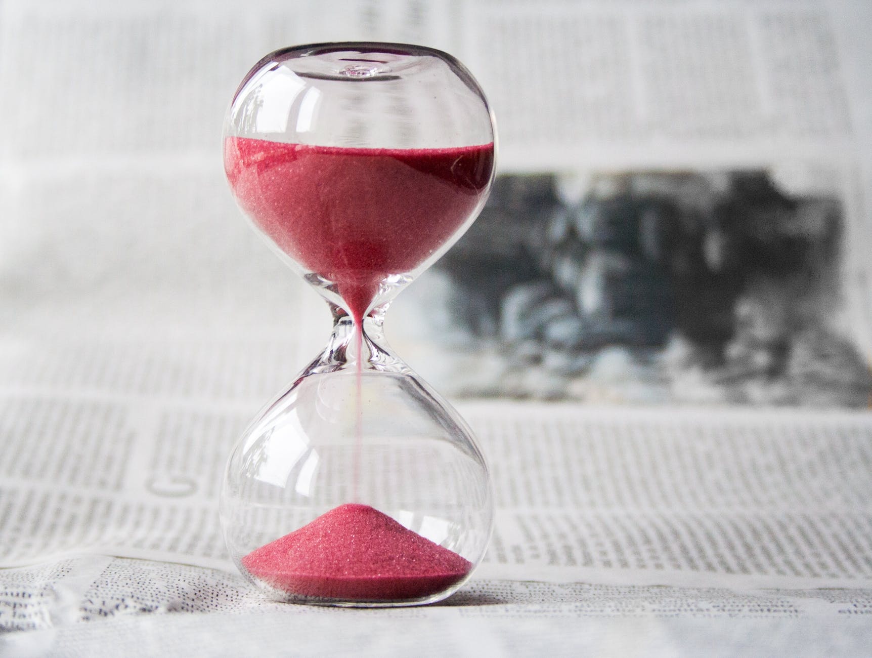 A sand timer with pink sand counting down